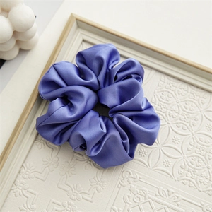Detail view of periwinkle blue floral satin scrunchie with elegant silk texture