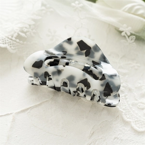 Detailed view of square acrylic hair claw clip with black and white marble pattern texture