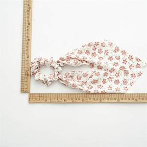 Floral print hair scrunchie with long ribbon bow showing 30cm length measurement