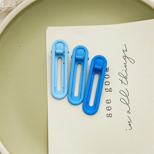 Three gradient blue oval hair clips on a white card with minimalist ins style design