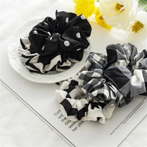 Detailed view of black and white patterned oversized scrunchies in cotton fabric texture