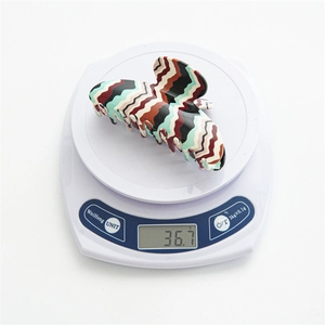 Detailed view of large acetate hair claw with vintage colorful zigzag pattern and glossy finish