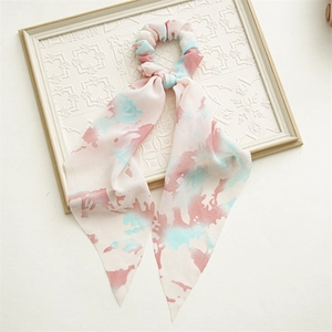 Detail view of pink and blue watercolor floral chiffon scrunchie with long ribbons