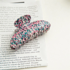 Detail of pink and cyan marble texture on large acetate shark hair claw clip