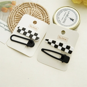 Detail view of checkerboard pattern hair clip set on aesthetic lifestyle background