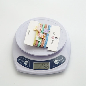 Set of 5 colorful high-elastic candy color hair ties with fruit fabric labels on a scale