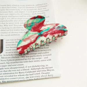 Detailed macro view of large acetate hair claw clip with colorful marble texture patterns