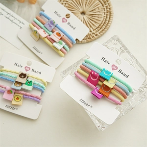 Detail of high-elasticity hair scrunchies with colorful cloth patches and animal patterns
