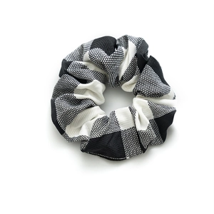 Classic black and white checkered hair scrunchie with vertical ribbed knit texture