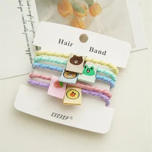 Detail of high-elasticity hair ties in pastel colors with cute cartoon fabric labels