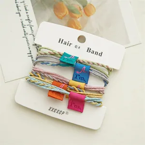 Detailed view of colorful macaron hair ties with cloth labels on a display card
