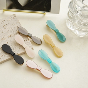 Set of seven colorful acetate bow hair clips with elegant gold metal base for women