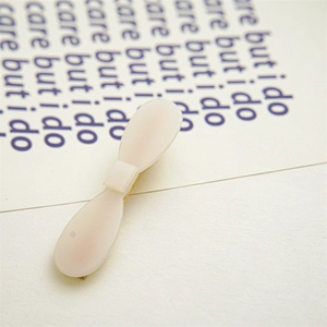 Close-up of a minimalist cream acetate hair clip with a sleek Korean-style resin finish