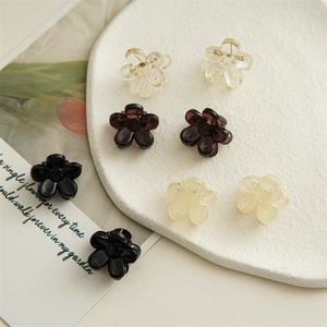 Mini 2cm flower claw clips in transparent, dark brown, cream, and black colors for hair