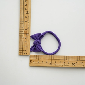 Three-pack elastic bow hair ties in purple knit fabric with precise 5.5cm diameter measurement