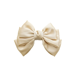 Three-layer satin bow hair clip in champagne gold with elegant layered silk texture