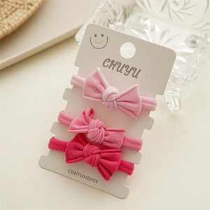 Three-pack pink bow hair ties on display card with high elasticity knit texture