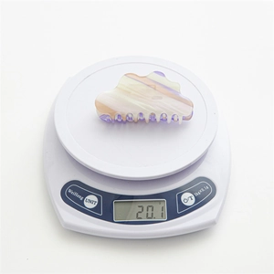 Iridescent cloud cloud-shaped acetate hair claw clip weighing 20.1g on a scale