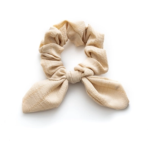 Elegant beige bow scrunchie with pleated texture for women minimalist hair style