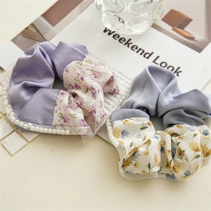 Floral fabric scrunchies set with pearlescent trim on minimal lifestyle background