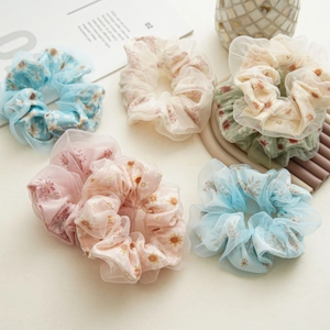 Elegant organza flower scrunchies with daisy prints in light blue, pink and green tones