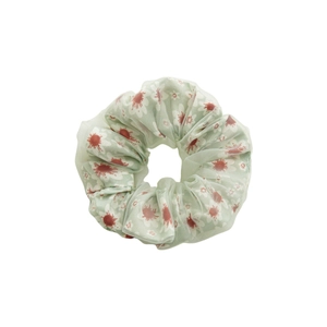 Double-layered mesh floral scrunchie with green base and white daisy flower patterns