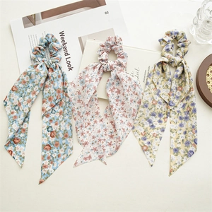 Three-piece floral bow ponytail scrunchie set in blue, pink, and yellow light fabric