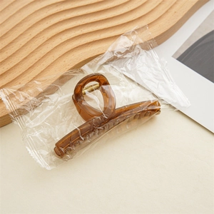 Elegant amber jelly hair claw clip with cross design for women's stylish hair styling