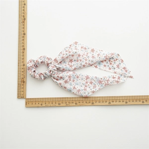 Floral print chiffon hair scrunchie with long ribbons shown with measurement ruler