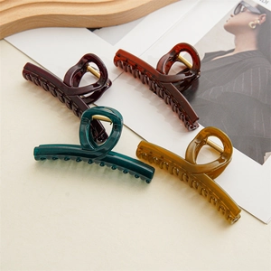 Macro shot of four colorful jelly resin hair claws with strong metal springs