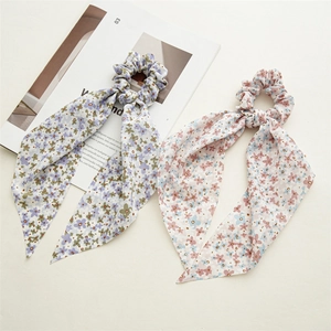 Detail view of floral chiffon hair scrunchies with long ribbons in blue and pink patterns