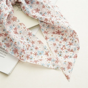 Detailed macro view of floral chiffon hair scarf scrunchie with pink and blue flower prints