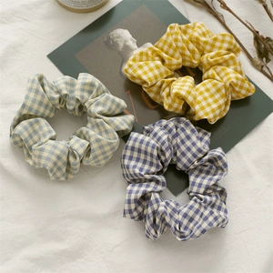 Three-piece set of plaid cotton scrunchies in yellow, light blue, and deep purple
