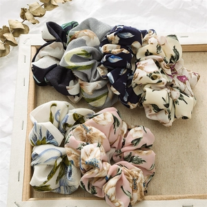 Close-up of floral fabric hair scrunchies with elegant textures and vintage flower patterns