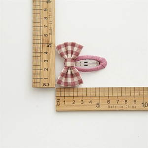 Red checkered fabric bow hair clip measuring 5.5cm on a white background