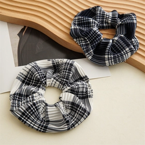 Classic plaid scrunchies with pleated fabric texture in navy blue and black patterns