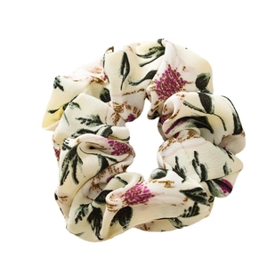 Floral print scrunchie in beige fabric with purple flowers for elegant hair styling