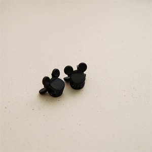 Close-up of matte black mini hair clips with cartoon mouse silhouette for girls