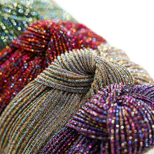 Macro shot of colorful metallic knotted headband with striped texture and sparkling yarns