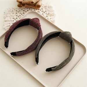 Close-up of knot headband set with sparkling metallic fabric and non-slip inner band