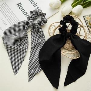 Detail of plaid and black scrunchies with long streamers on a stylish aesthetic background