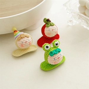 Handmade crochet hair clips set featuring a cute green frog, red apple, and rainbow hat