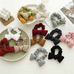 Close-up of colorful knit bow scrunchies with pleated texture and elastic hair ties