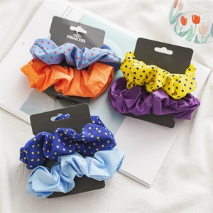 Detail view of 6-piece polka dot and solid scrunchie set on minimalist gift cards