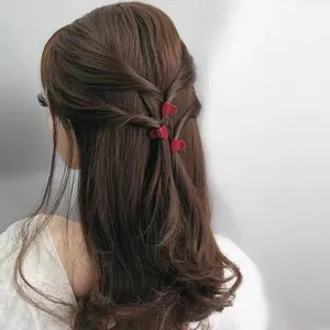 Detailed view of red velvet heart hair clips worn on back of hair for a stylish look