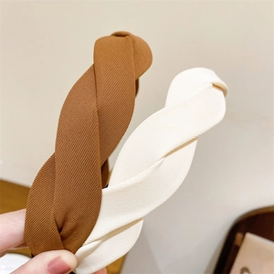 Detail of twisted fabric headband showing high-quality texture in brown and beige