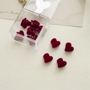 Detail showing mini burgundy velvet heart hair clips in a clear acrylic gift box