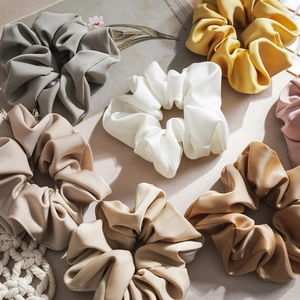Detailed view of assorted satin and matte scrunchies in elegant Morandi colors