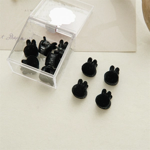 Set of 10 mini black velvet rabbit hair clips presented in a clear storage box