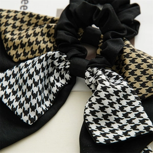 Detailed view of houndstooth bow scrunchie with high-quality polyester twill texture